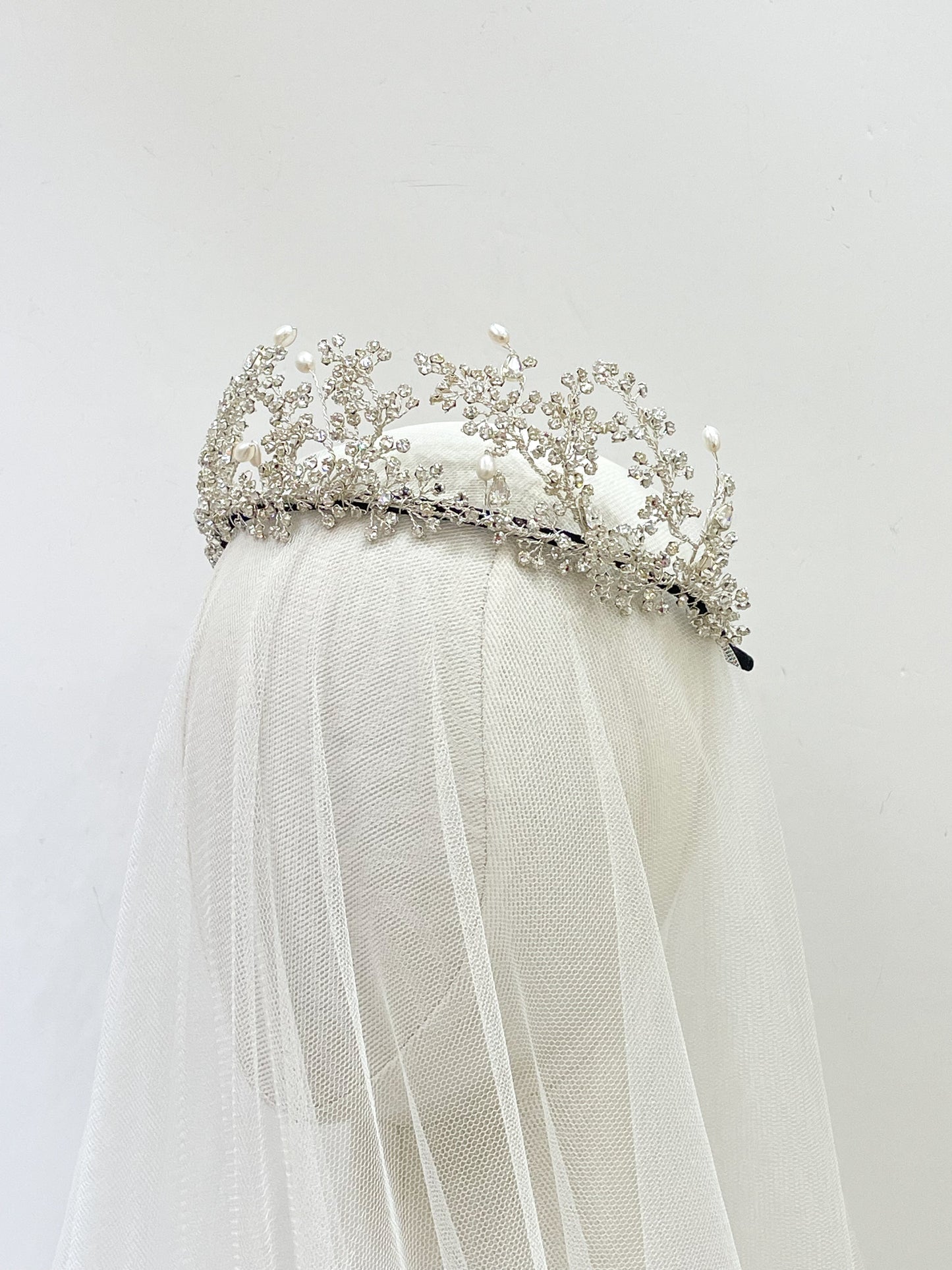 Wuthering Heights Silver tiara with pearls on a white veil against a light gray background